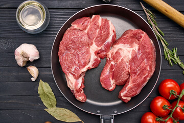 meat steak in a frying pan food ingredients kitchen wooden table