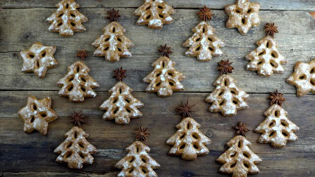 Christmas tree cookies on wooden background. New Year's food. Anise star. Festive baked goods. Gingerbread on the table. Icing sugar sweetness taste season