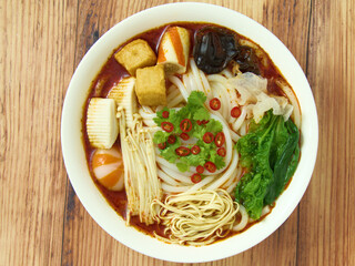 Closeup of udon noodles with tofu skin, fungus, enoki mushroom, top view