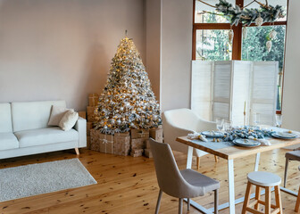 Classic christmas New Year decorated interior room. Christmas tree with gold and silver ornaments. A large beautifully decorated Christmas tree with gift boxes stands in room. Christmas eve at home