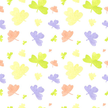 Seamless pattern on white background. St. Patrick's Day decor. Multicolored clover leaves painted in watercolor. Pastel colors. For packaging paper or fabric.