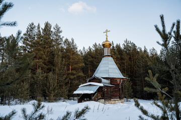 Orthodox church chapel stands in the winter forest. Russia Epiphany frosts. A place for prayer. The old church is lost in the taiga. Quiet location