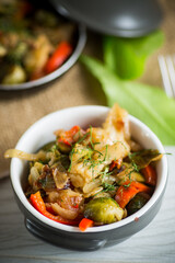 fried brussels sprouts with cauliflower and other vegetables in a bowl