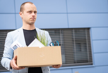 Portrait of a young man who lost his job. He doesn't know what to do, he is stressed. Unemployment rate growing.