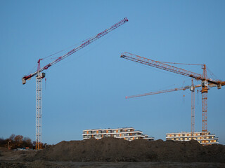 Construction cranes on a newly built housing estate © Michal