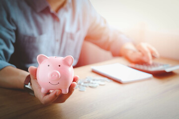 Pink piggy bank on hand for account save money. Planning step up, saving money for future plan,...