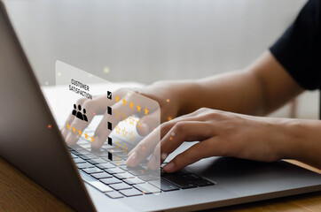 male hand using computer Notebook with five-star pop-up icon for feedback, evaluation, review,...