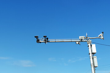 road cameras on a pole against the sky