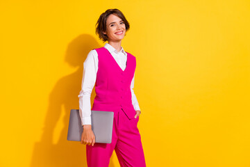 Photo of pretty charming young woman dressed pink suit smiling holding modern gadget empty space...