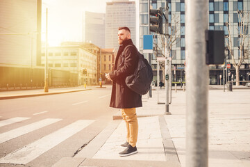 Young bearded caucasian elegant man outdoor stopping at traffic light strolling city