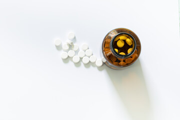 pills and pill bottles on white background,Pills spilling out of pill bottle on white background