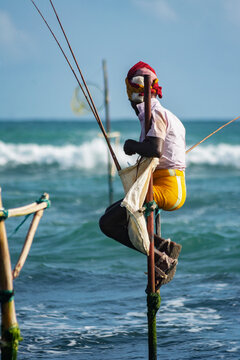 Traditional stilt fisherman fishing in ocean in Sri Lanka