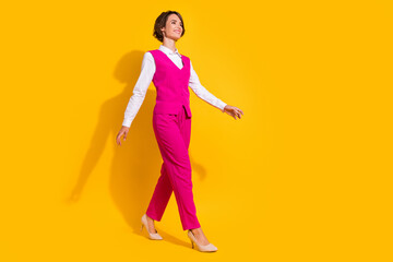Fototapeta na wymiar Full length photo of bossy millennial brunette lady go wear pink suit stilettos isolated on yellow background