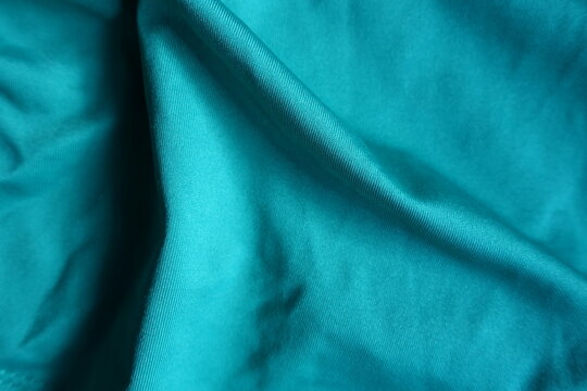 Folded blue green polyester fabric from above