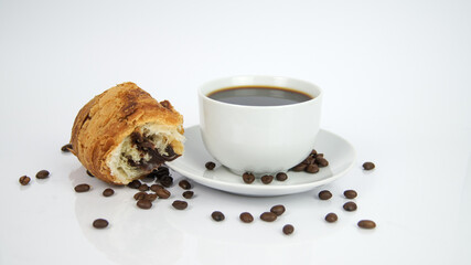 Cup of Americaano Black Coffee on plate, croissant with hazelnut and chocolate filler and seeds on white background. Enjoyment and freshness. Graphic for kitchen or cafe store. Render graphic for shop
