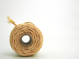 A reel with jute twine lying on the side and a view from the end. Copy space