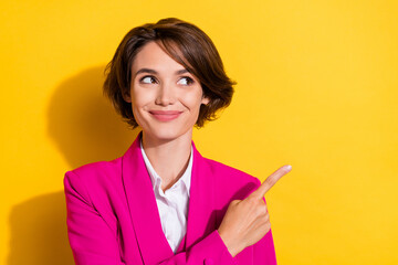 Photo of sweet young brunette lady look point empty space wear pink blazer isolated on yellow color background