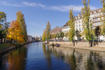 Fototapeta na wymiar France, Strasbourg, Ill River canal with promenade and row of townhouses