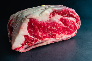 Raw Bone-in Standing Prime Rib Roast: Uncooked rib roast tied with kitchen twine