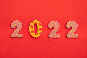 Decorative numbers 2022 new year on red background with copy space