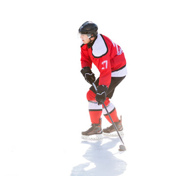 Professional ice hockey player in attack on the rink. Isolated image on white