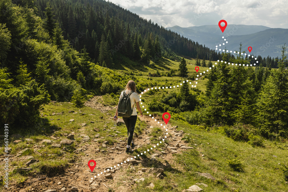 Wall mural woman traveler explorer with backpack hiking to the top of the mountain. adventure weekend.