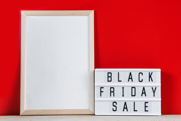 Black Friday concept. Sign and empty frame on red background.