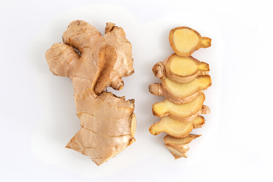 Fresh ginger root and slides on white background, herb medical concept, Top view.