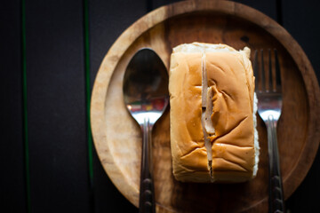 Obraz na płótnie Canvas Bread on a wooden plate ready to serve