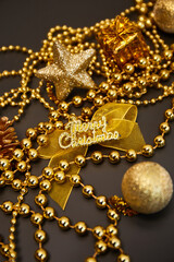 Christmas golden decorations with gift boxes on dark background. Template for greeting card