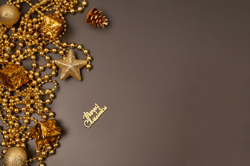 Christmas golden decorations with gift boxes on dark background. Template for greeting card. Copy space