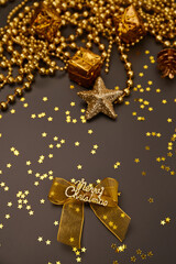 Christmas golden decorations with gift boxes on dark background. Template for greeting card