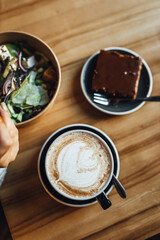 Women drinking Chai Latte at coffee shop, seasonal coffee drinks with latter art.