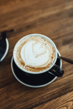 Women Drinking Chai Latte At Coffee Shop, Seasonal Coffee Drinks With Latter Art.