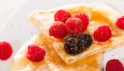 pancakes with raspberries, blackberries and honey