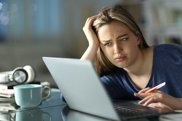 Frustrated student e-learning in the night at home