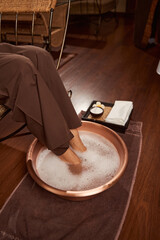 Client having foot bath in wellness center