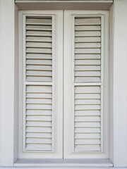 Fototapeta premium Front view of closed white shutter in Caribbean colonial house. Architecture and construction of the French Antilles. Creole style.