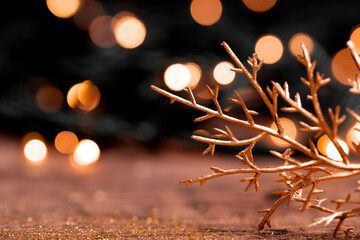 Festive New Year card with free space for text. Golden Christmas decorations on a dark background with beautiful bokeh