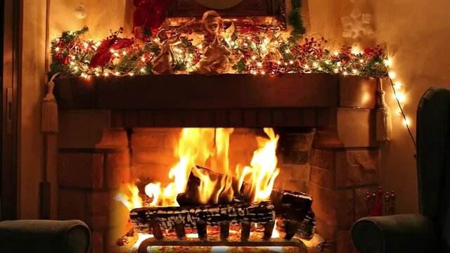 Christmas Yule Log In Fireplace Decorated With Christmas Angel And Garlands Lights, Ornaments, Baubles