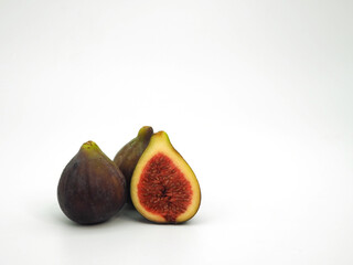 Fresh figs and cut in half isolated on white background