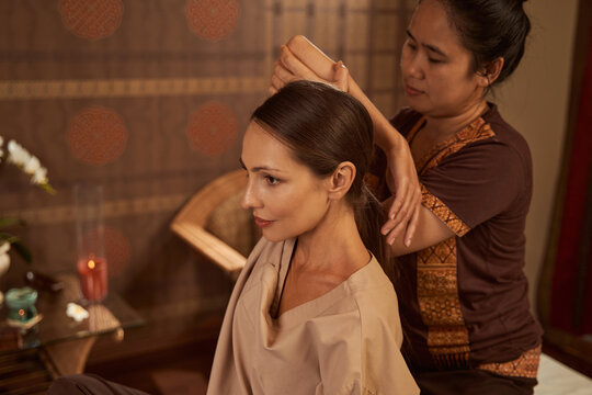 Dreamy Calm Female Client During Assisted Stretching Procedure