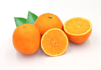 halved orange and green leaves isolated on white background