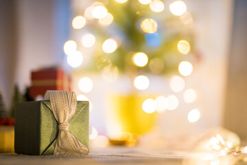 new year gift box with lighting on christmas tree background