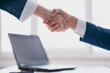 colleagues shaking hands successful deal office laptop professionals