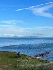 disabled person looking at view of sea with Isle of Wight in the background