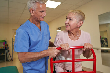 Stroke patient using walking frame in medical clinic