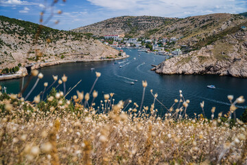 Balaklava bay from the hill. Summer season, dry foliage in foreground. Travel tourism concept