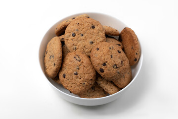 Giant handmade cookies with chocolate chips in plate isolated on white background. Top view.