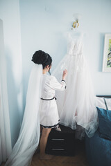 Portrait of beautiful bride with fashion veil at wedding morning